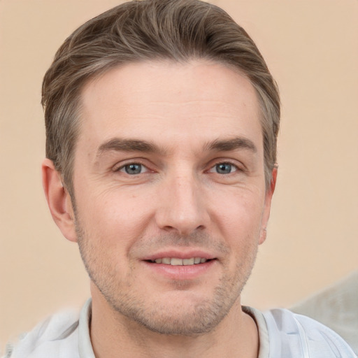 Joyful white adult male with short  brown hair and grey eyes