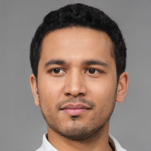 Neutral latino young-adult male with short  black hair and brown eyes