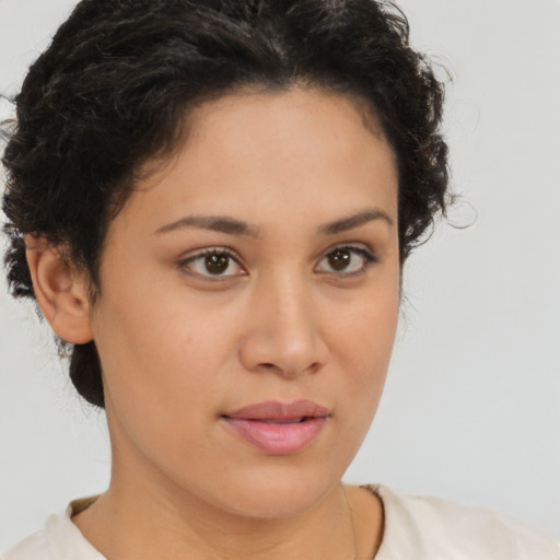 Joyful latino young-adult female with short  brown hair and brown eyes