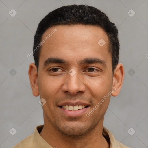 Joyful latino young-adult male with short  black hair and brown eyes