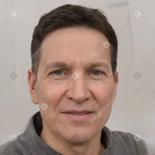 Joyful white adult male with short  brown hair and grey eyes