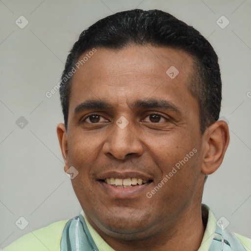 Joyful latino young-adult male with short  black hair and brown eyes