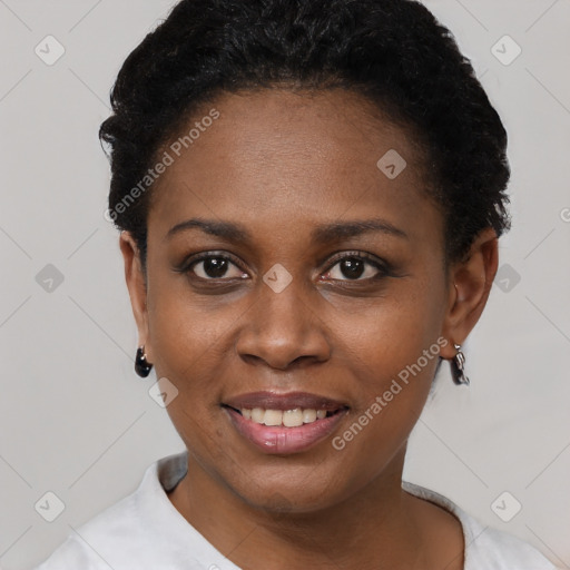 Joyful black young-adult female with short  black hair and brown eyes