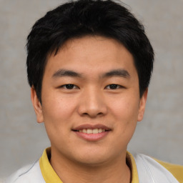 Joyful asian young-adult male with short  black hair and brown eyes
