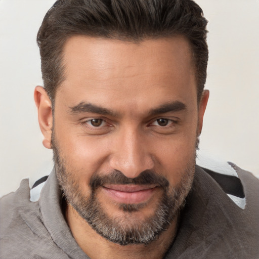 Joyful white adult male with short  brown hair and brown eyes