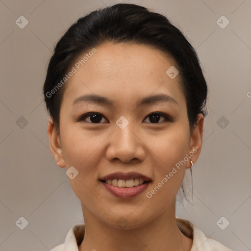 Joyful asian young-adult female with short  brown hair and brown eyes