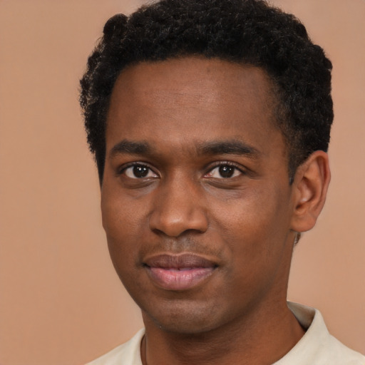 Joyful black young-adult male with short  brown hair and brown eyes