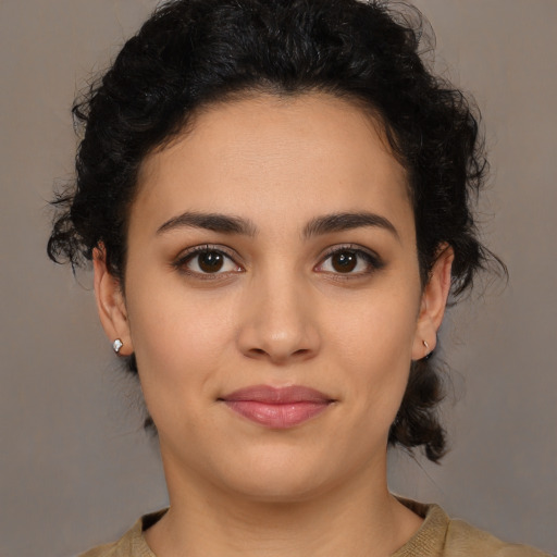 Joyful latino young-adult female with medium  brown hair and brown eyes