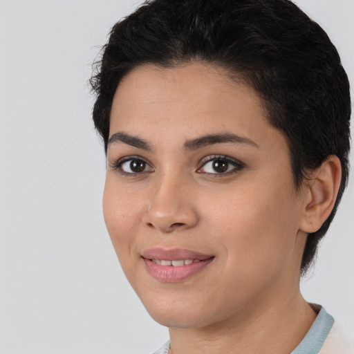 Joyful latino young-adult female with short  black hair and brown eyes