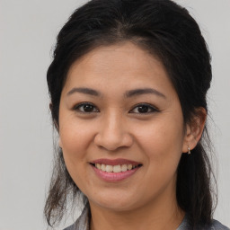 Joyful asian young-adult female with long  brown hair and brown eyes