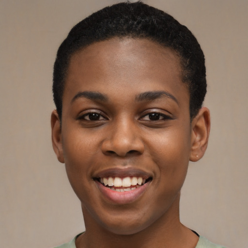 Joyful black young-adult female with short  black hair and brown eyes