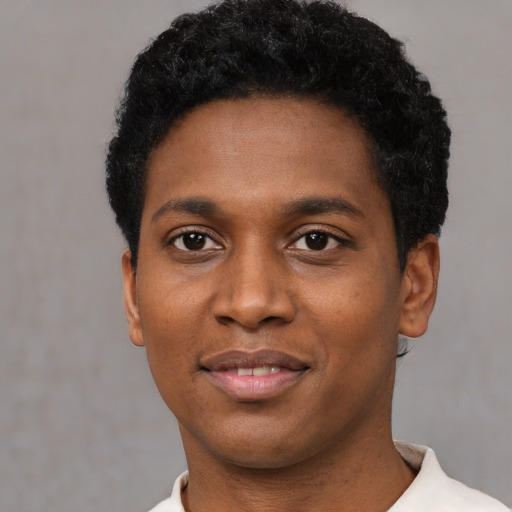 Joyful black young-adult male with short  black hair and brown eyes