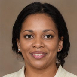 Joyful black adult female with medium  brown hair and brown eyes