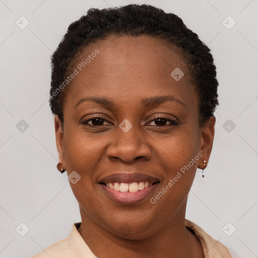 Joyful black young-adult female with short  brown hair and brown eyes