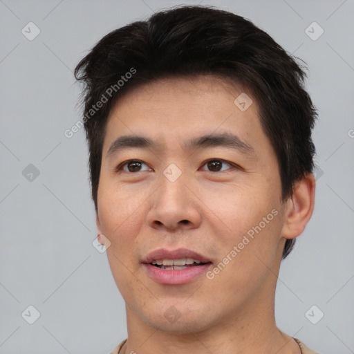 Joyful asian young-adult male with short  brown hair and brown eyes
