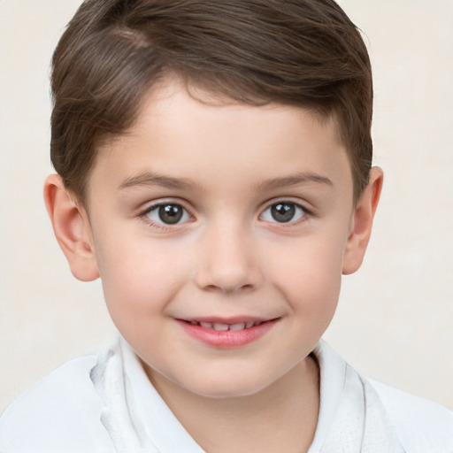 Joyful white child male with short  brown hair and brown eyes