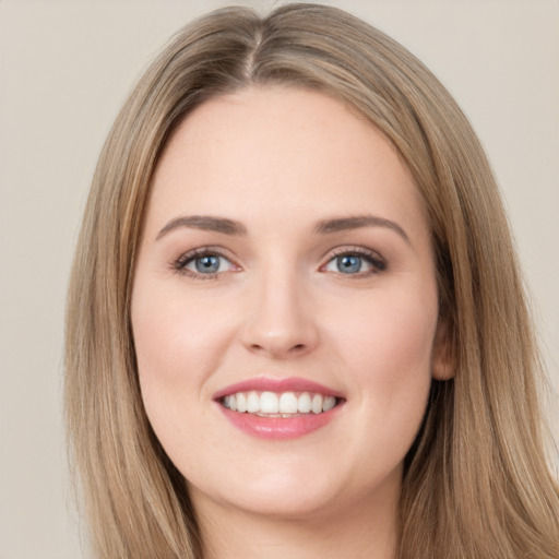 Joyful white young-adult female with long  brown hair and green eyes