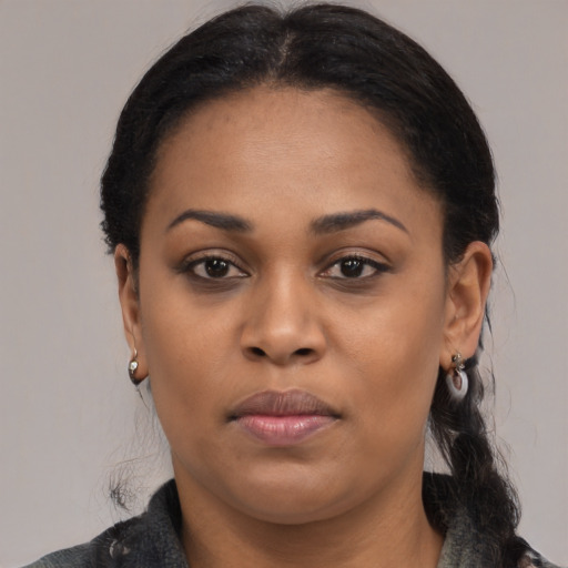 Joyful black young-adult female with medium  black hair and brown eyes