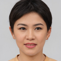 Joyful asian young-adult female with short  brown hair and brown eyes