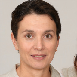 Joyful white adult female with short  brown hair and brown eyes