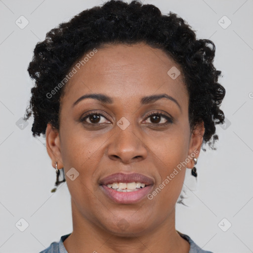 Joyful black adult female with short  brown hair and brown eyes