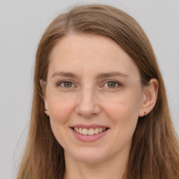 Joyful white young-adult female with long  brown hair and grey eyes