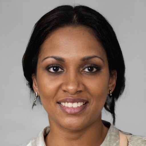 Joyful black young-adult female with medium  black hair and brown eyes