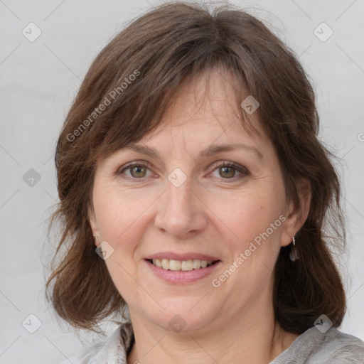 Joyful white adult female with medium  brown hair and grey eyes