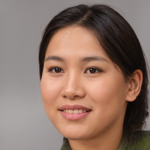 Joyful asian young-adult female with medium  brown hair and brown eyes