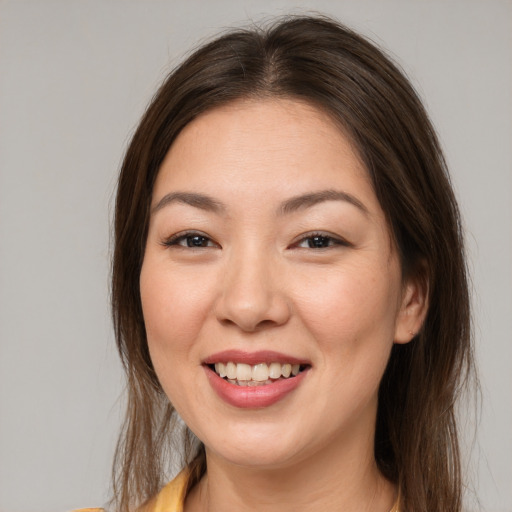Joyful white young-adult female with medium  brown hair and brown eyes