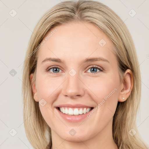 Joyful white young-adult female with long  brown hair and blue eyes