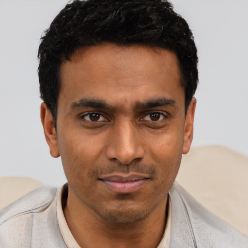 Joyful latino young-adult male with short  brown hair and brown eyes
