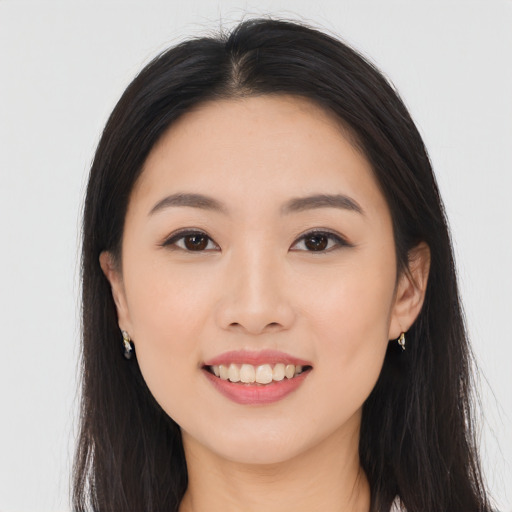 Joyful asian young-adult female with long  black hair and brown eyes