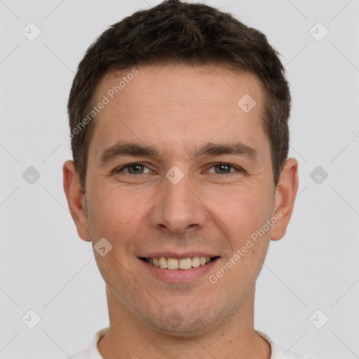 Joyful white young-adult male with short  brown hair and brown eyes