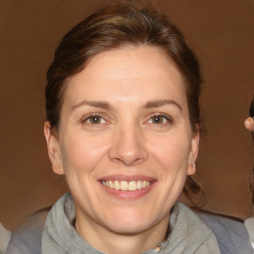 Joyful white adult female with short  brown hair and grey eyes