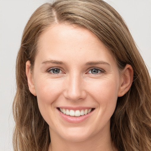 Joyful white young-adult female with long  brown hair and grey eyes