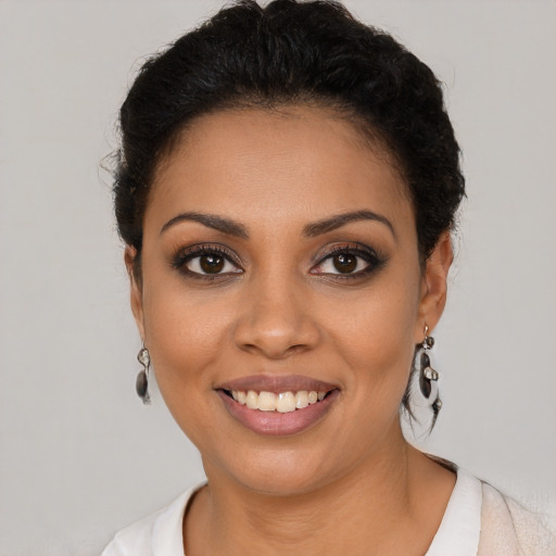 Joyful latino young-adult female with short  brown hair and brown eyes