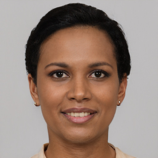 Joyful latino young-adult female with short  black hair and brown eyes