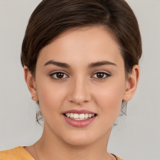 Joyful white young-adult female with short  brown hair and brown eyes