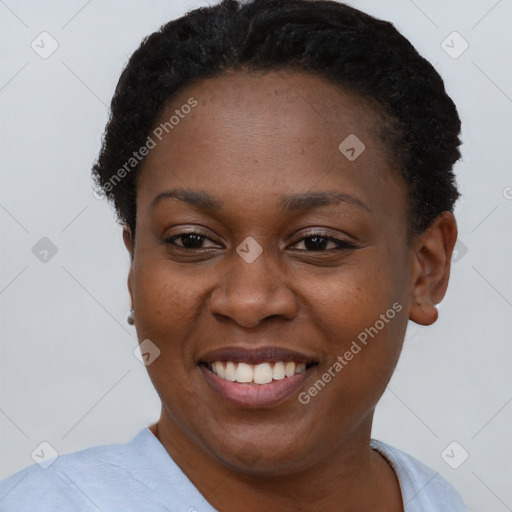 Joyful black young-adult female with short  brown hair and brown eyes