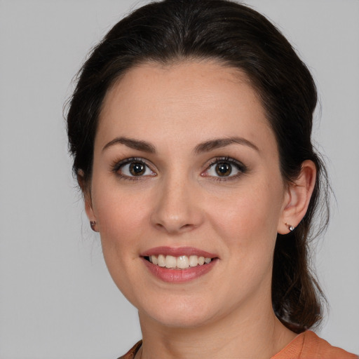 Joyful white young-adult female with medium  brown hair and brown eyes