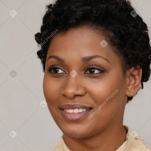 Joyful black young-adult female with short  brown hair and brown eyes