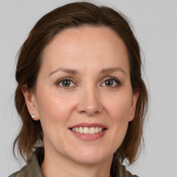 Joyful white adult female with medium  brown hair and grey eyes