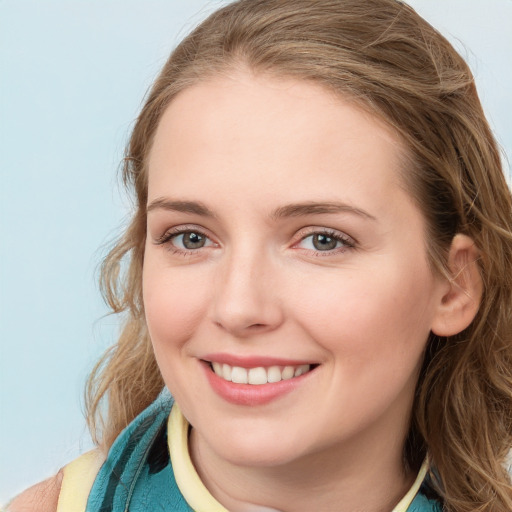 Joyful white young-adult female with long  brown hair and blue eyes