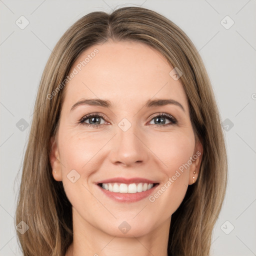 Joyful white young-adult female with long  brown hair and green eyes