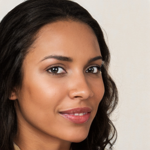 Joyful latino young-adult female with long  brown hair and brown eyes