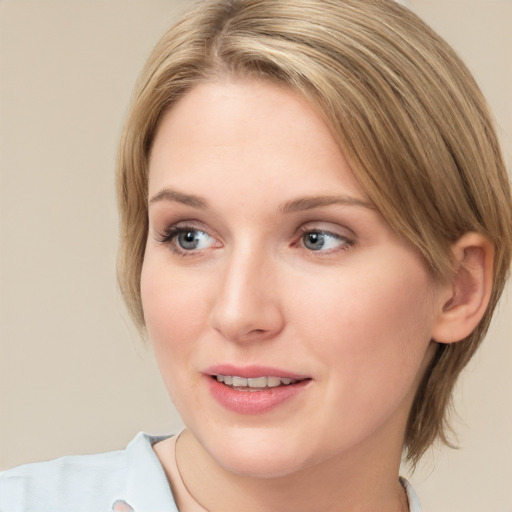 Joyful white young-adult female with medium  brown hair and blue eyes