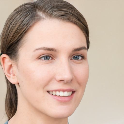 Joyful white young-adult female with medium  brown hair and grey eyes