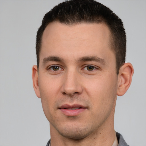 Joyful white young-adult male with short  brown hair and brown eyes