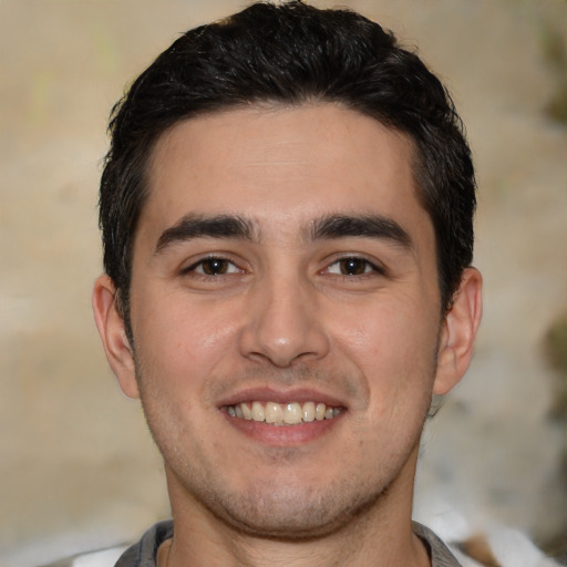 Joyful white young-adult male with short  black hair and brown eyes